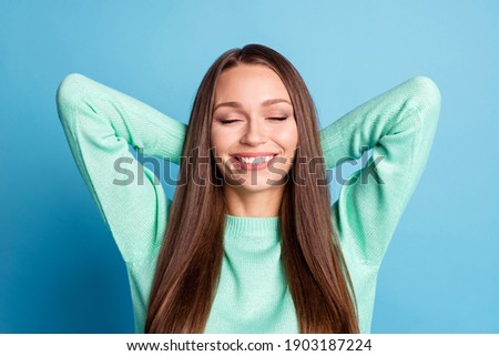 Photo portrait of chilling girl with hands behind back isolated on pastel blue colored background