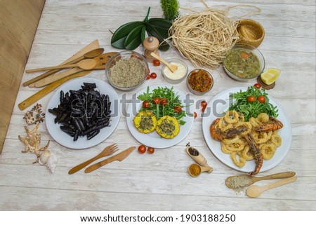 Composition of several Italian dishes, special Italian ingredients and preparations. Picture in top view with culinary decoration in background.