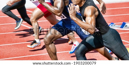 Cropped photo of athlete runners running on track