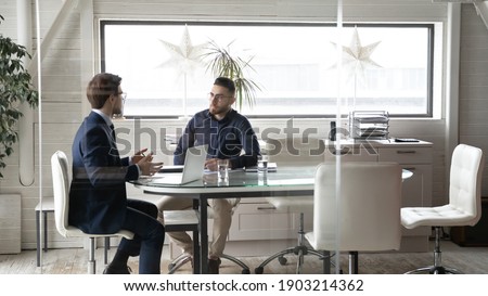 Diverse business partners negotiations, colleagues talking, working on project together, sitting in modern boardroom, discussing startup ideas, hr manager holding job interview with candidate Royalty-Free Stock Photo #1903214362