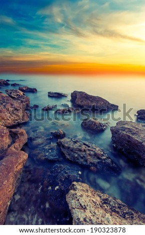 The rocky shore of the Black Sea at sunset. Vintage picture