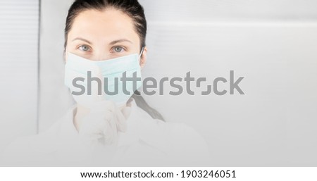 banner nurse in medical mask gesture to be quiet with finger on lips. Concept not spreading rumors about coronavirus Covid 19, silence, secret, keep voice down concept. Blurred gradient for your text