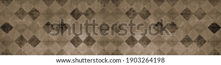 Old brown beige worn vintage shabby patchwork mosaic tiles wallpaper stone concrete cement wall texture background banner, with rhombus diamond rue lozenge square print	 Royalty-Free Stock Photo #1903264198