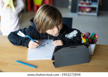 Boy drawing minecraft pixel arts.