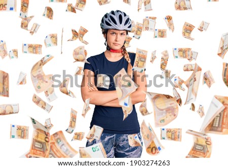 Beautiful caucasian woman wearing bike helmet skeptic and nervous, disapproving expression on face with crossed arms. negative person.