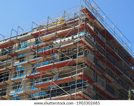 Scaffolding in front of a building shell on a construction site