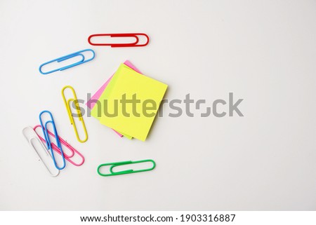 Selective focus of colorful sticky notes and paper clips. Flat lay, top view. Copy space.  Royalty-Free Stock Photo #1903316887