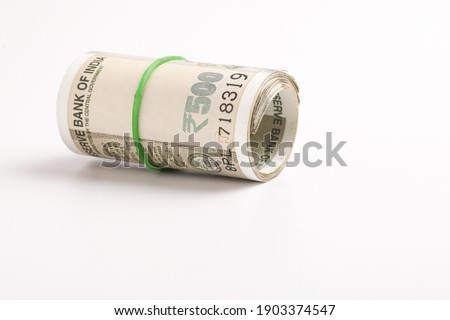 A stack of five hundred rupee notes (Indian currency) isolated on a white background. Royalty-Free Stock Photo #1903374547