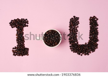 Valentine's background concept with coffee lovers. Combination of a white cup with coffee beans and a heart shaped cut of paper. Template design. Let's celebrate Valentine's Day by enjoying coffee.