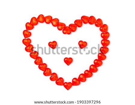 Beautiful heart in form of face with eyes, nose consists of small red figures of hearts. Сoncept of congratulations for Valentines Day, holidays, Love. Isolated on white background. Flatly, top view