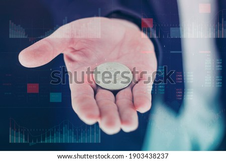 Businessman holds a gold bitcoin coin in his hands. Information holographic panel with statistics shows the fall and growth of the cryptocurrency. Virtual currency and blockchain concept