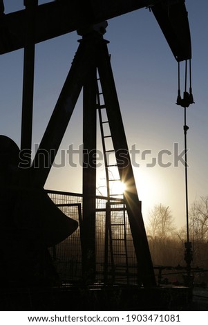 Part of picture of Pump jack silhouette background sunset in the oilfield in Texas