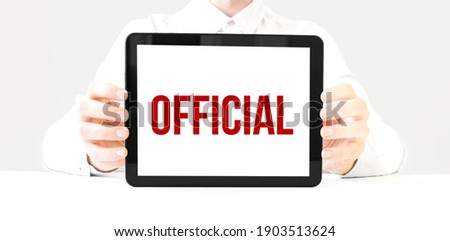 Text official on tablet display in businessman hands on the white bakcground. Business concept