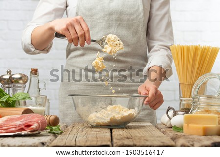 Chef making dough, working with flour Cooking baked goods - carbonara paste, Italian pasta Freezing in motion Recipe book, cooking and gastronomy