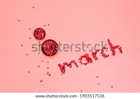 Glitter lettering Red sparkles in the shape of 8 eight march on pink background Happy International Women's Day concept Flat lay
