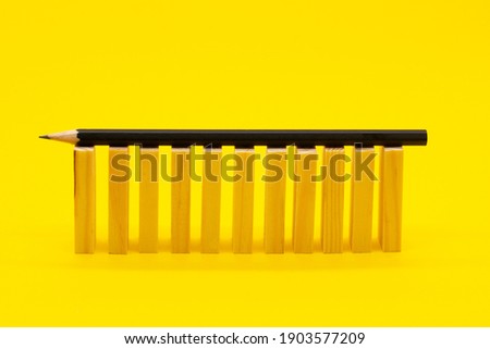 wooden blocks on a yellow background and a pencil. Business concept.
