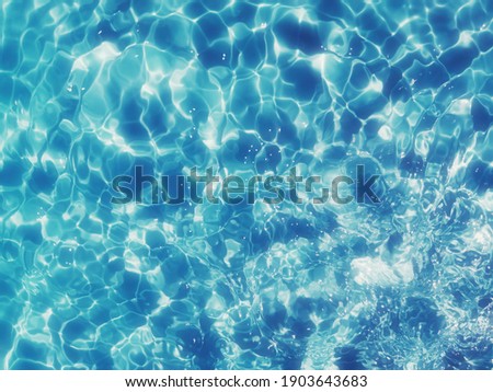 Reflection​ on surface​ blue​ water​ for​ background.  Abstract​ of​ surface​ blue​ water​ for​ background.