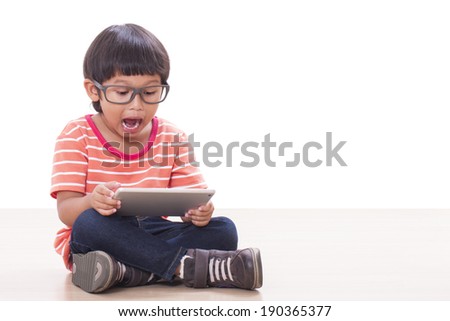 Cute boy playing a game on computer tablet 