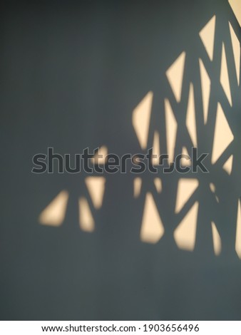 The shadow of sunlight on a white background.