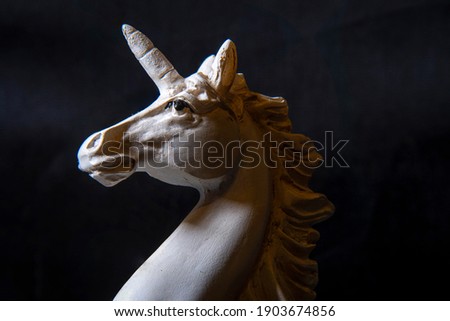 Portrait of a white unicorn on a black background