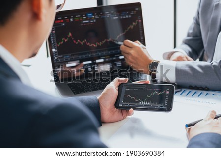 Businessman talking about investment stock market and graph from computer laptop with broker trader, giving money plan management and analysis Royalty-Free Stock Photo #1903690384