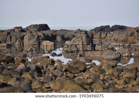 Sea coast with boulders at Manori beach Mumbai