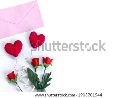 Valentine's Day background,Pink envelope and hearts and red roses on white background with copy space