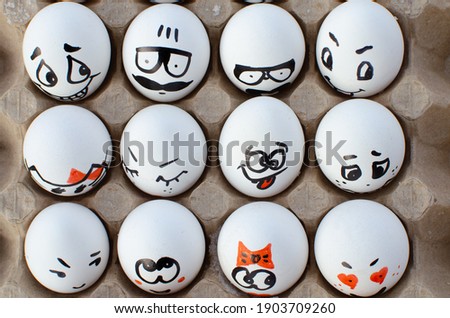 White eggs with painted faces. Emotions on eggs.