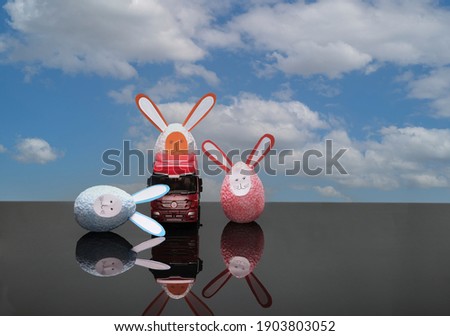easter bunnies with car on the background of the sky