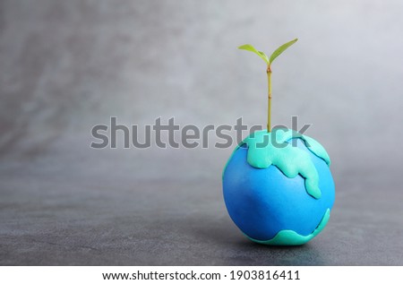 Plasticine globe and tree. Planting tree in green globe, Environment conservation.