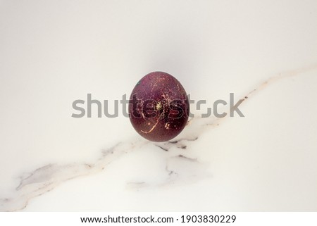 Minimal easter concept of brown egg. Stylish Easter brown on white marble background. The flat lay fashionable easter. Happy easter card with copy space for text