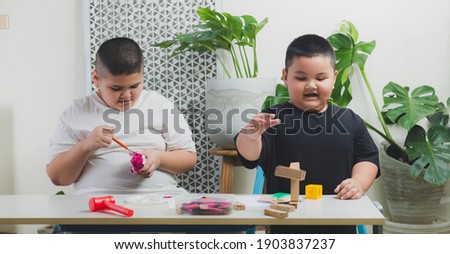 Brother and brother learn and do activities in the home.