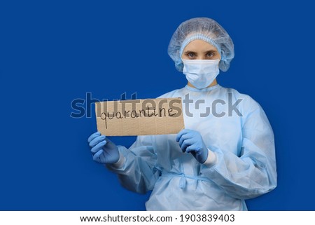 Doctor woman in protective mask holding poster Quarantine