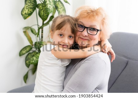 Cheerful woman taking care of her grandmother At Home.