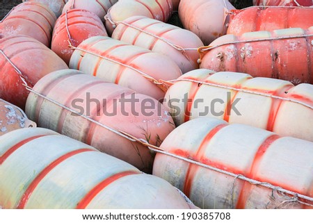 Old buoys on ground at outdoor storage.