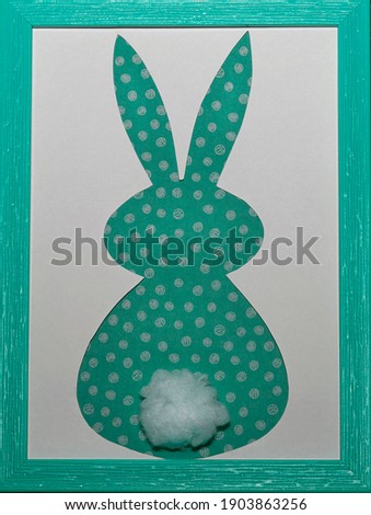 Easter bunny craft paper applique in aquamarine color photo frame on a white background. Top view. Happy Easter Day concept. Minimalizm. Easter card.                           