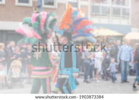 Blurry background of carnival parade of the world, traditional festival with man  in mix colors costume and deco with hat or crown feather, funny and happy  national culture.