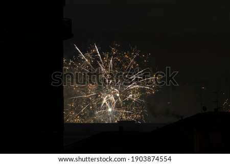 Night shot of a city rooftops with fireworks for new year's eve.