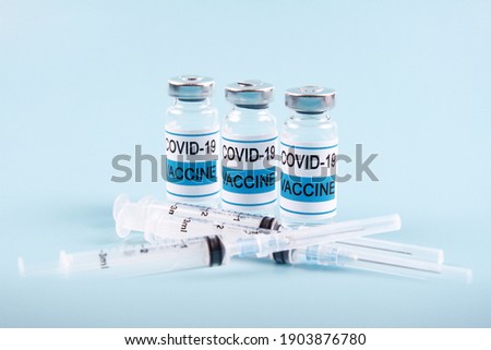 The Nobel coronavirus vaccine covid-19 is a bottle with an illustrative picture and a syringe for injection. The concept of prevention,immunization, vaccination and treatment of coronavirus infection.