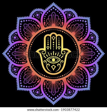 Color Circular pattern in form of mandala with ancient hand drawn symbol Hamsa for decoration. Decorative ornament in oriental style. Rainbow design on black background. "Hand of Fatima". Royalty-Free Stock Photo #1903877422