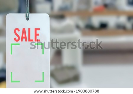 Blur photo - abstract image for the background. Sale signs in shop window,Sale promotion notice in the shopping mall