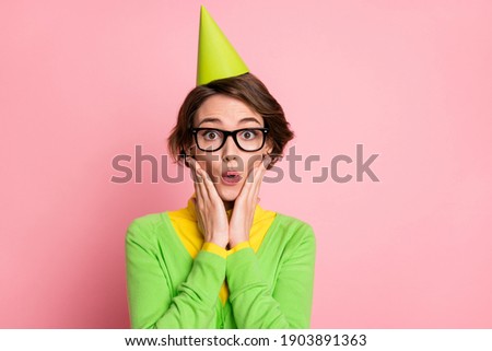 Photo of shocked pretty young woman birthday surprise wear cone hat isolated on pastel pink color background
