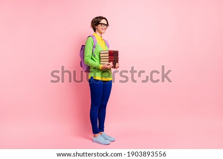 Full length photo of woman wear green cardigan spectacles rucksack holding book empty space isolated pink color background