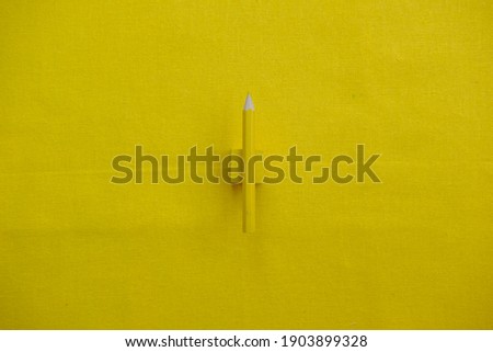 Top view pencil on yellow background
