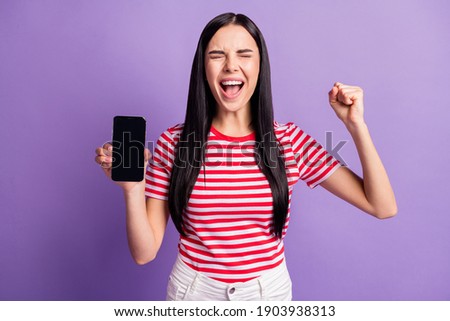 Photo of trendy stylish beautiful brown haired woman show phone hold fist closed eyes victory isolated on violet color background