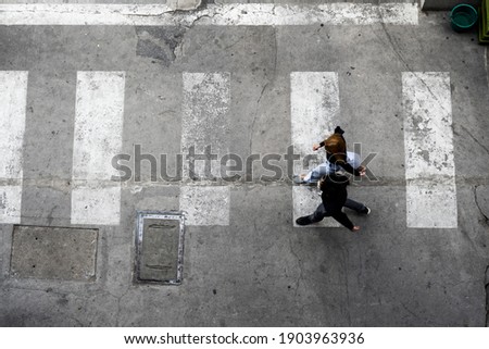 Aerial photo top view of people walk on street in the city over pedestrian crossing traffic road Royalty-Free Stock Photo #1903963936