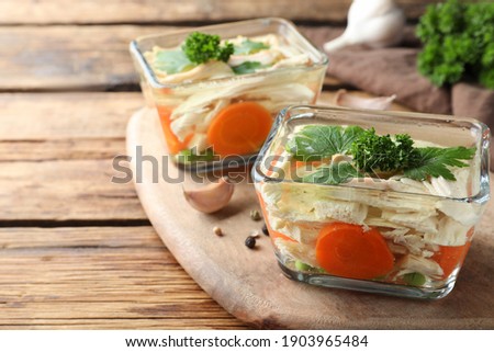 Delicious chicken aspic served on wooden table, closeup