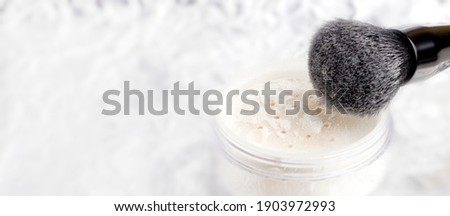 White matting powder with a black brush on a white background. Royalty-Free Stock Photo #1903972993