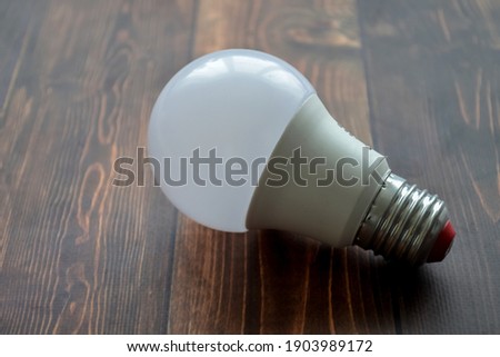 LED light bulb on wooden background