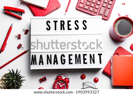 Flat lay composition of lightbox with phrase Stress Management on white table